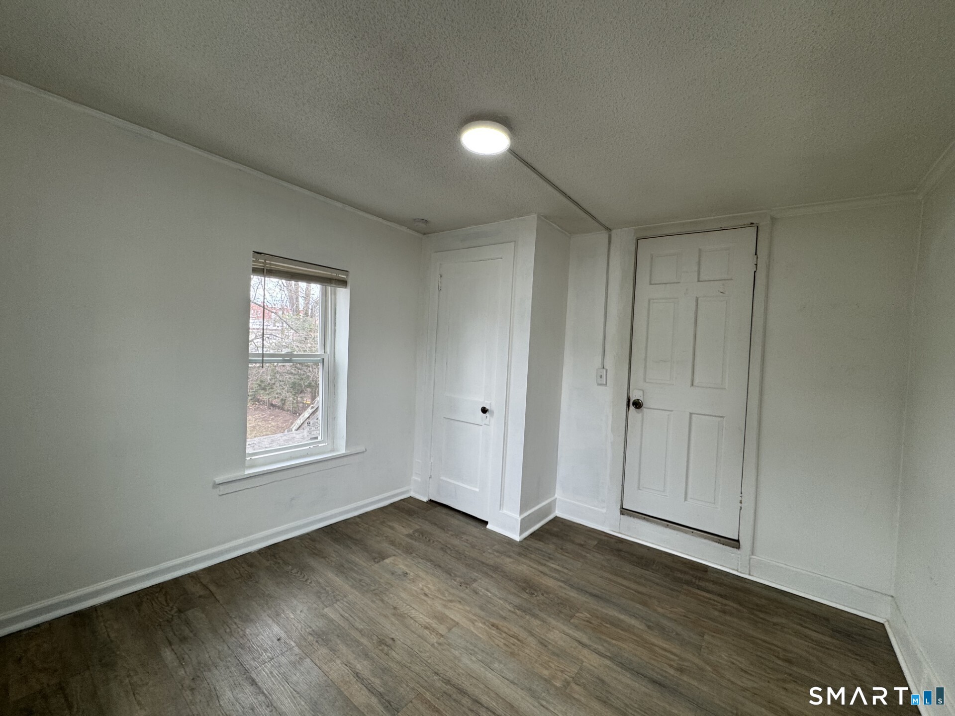 34-36 Cottage Street Manchester, CT 06040 - Photo 29 of 40 an empty room with wooden floor and windows