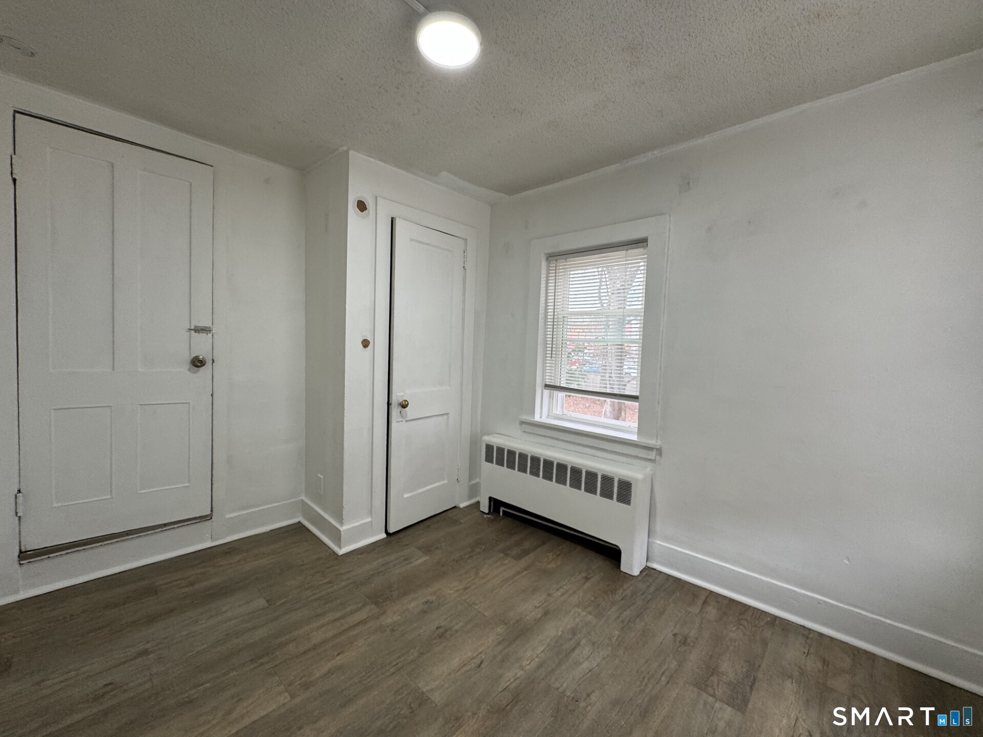34-36 Cottage Street Manchester, CT 06040 - Photo 31 of 40 an empty room with wooden floor and windows