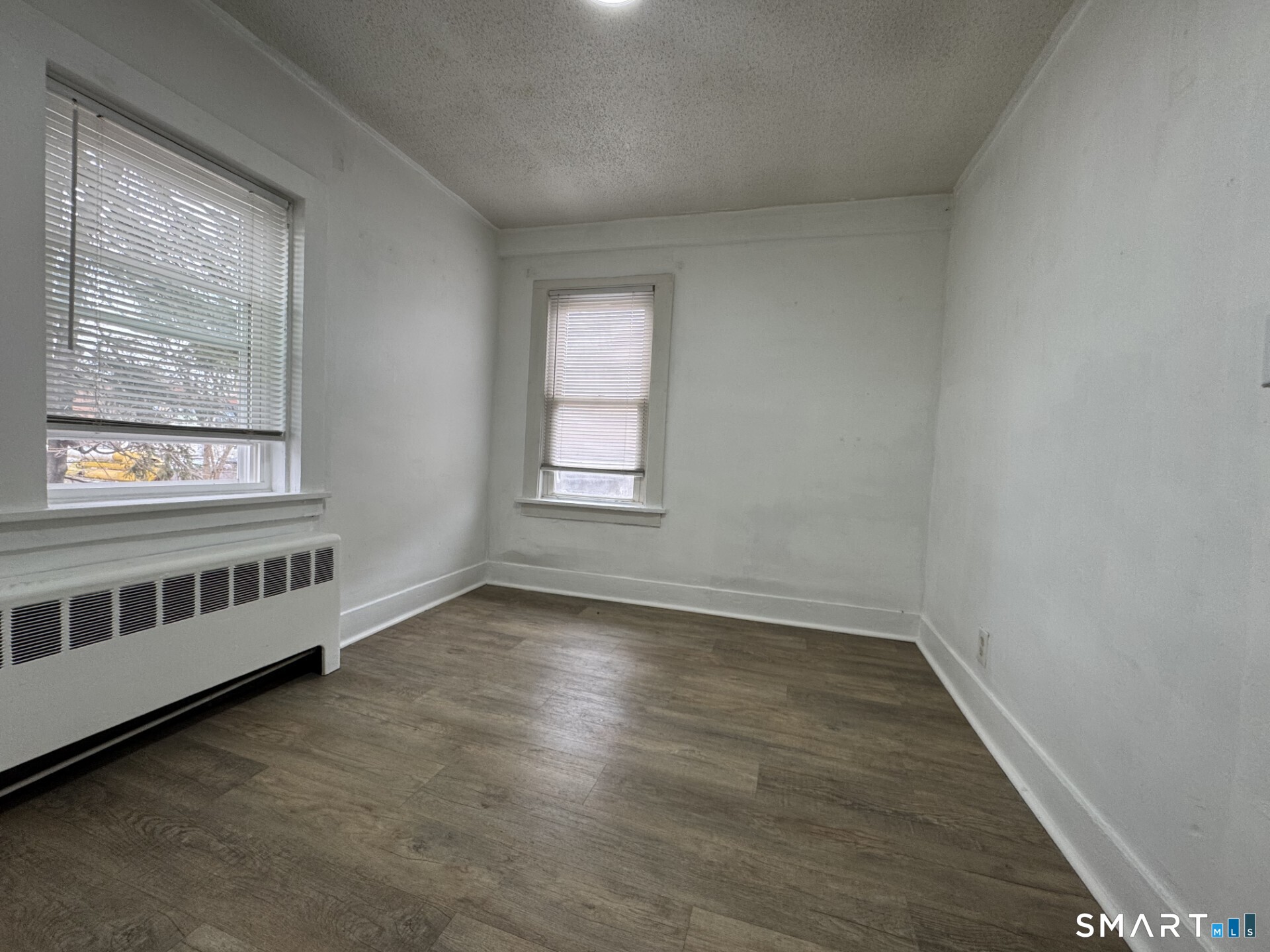 34-36 Cottage Street Manchester, CT 06040 - Photo 32 of 40 an empty room with wooden floor and windows