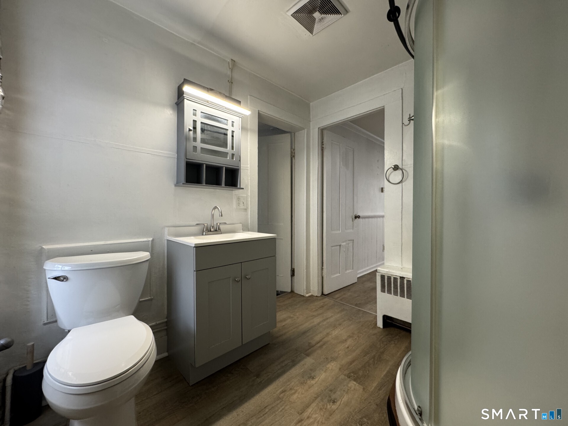 34-36 Cottage Street Manchester, CT 06040 - Photo 35 of 40 a bathroom with a toilet a sink a mirror and vanity