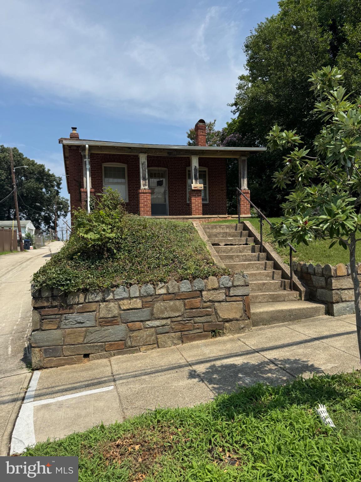 2208 R Street Southeast Washington, DC 20020 - Photo 1 of 6 Charming brick home with lush greenery.