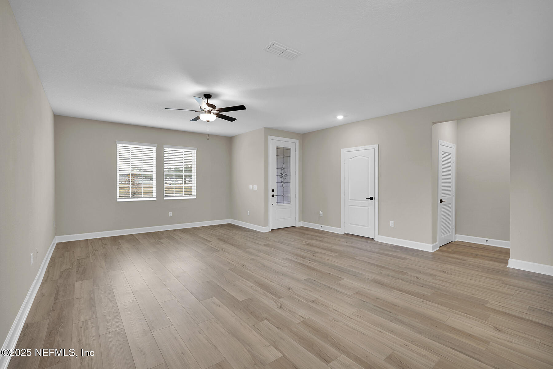 3956 Gareys Ferry Way Middleburg, FL 32068 - Photo 3 of 28 a view of an empty room with a window and a ceiling fan
