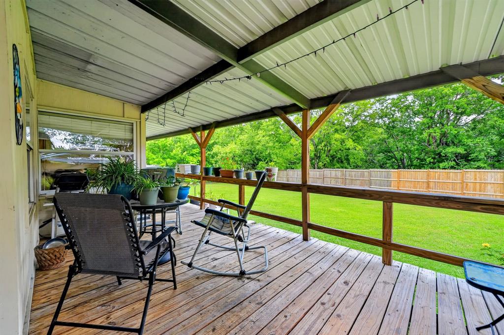 111 County Road 2806 Mabank, TX 75147 - Photo 23 of 34 Covered rear deck featuring wood-finish flooring, a metal roof, and wood railing