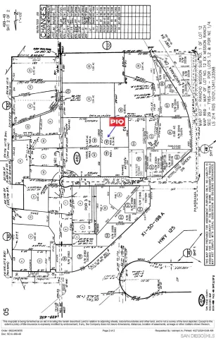 an aerial view of a house with a yard and large tree