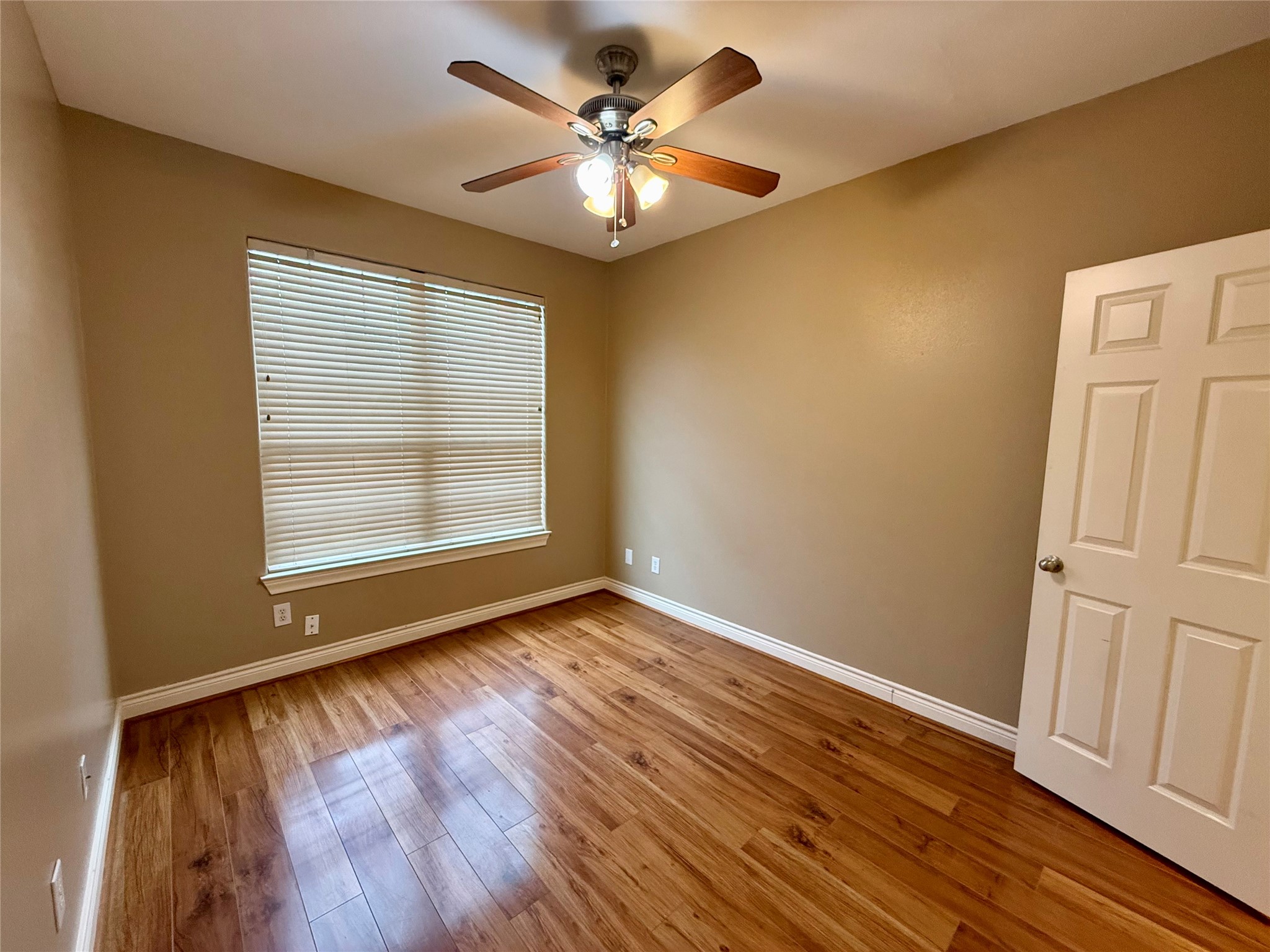 3540 Cline Street Houston, TX 77020 - Photo 17 of 26 a view of an empty room with window and wooden floor