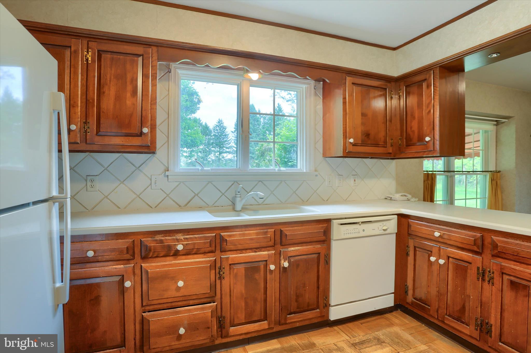 2919 Arcona Road Mechanicsburg, PA 17055 - Photo 11 of 49 a kitchen with granite countertop wooden cabinets a sink and a window