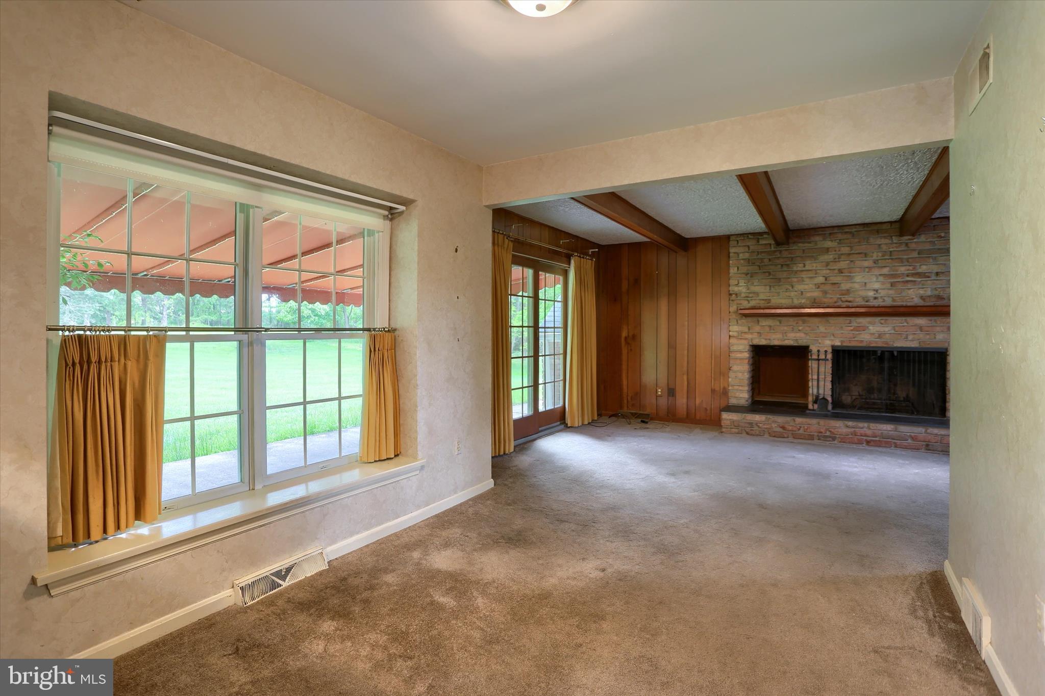 2919 Arcona Road Mechanicsburg, PA 17055 - Photo 14 of 49 a view of an empty room with a fireplace and a window