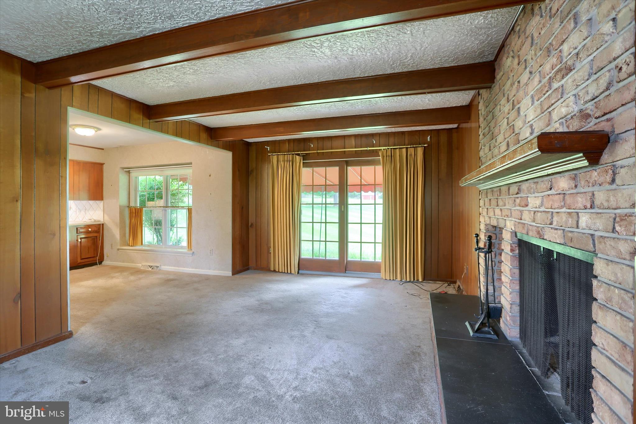 2919 Arcona Road Mechanicsburg, PA 17055 - Photo 16 of 49 a view of an empty room with a fireplace and a window