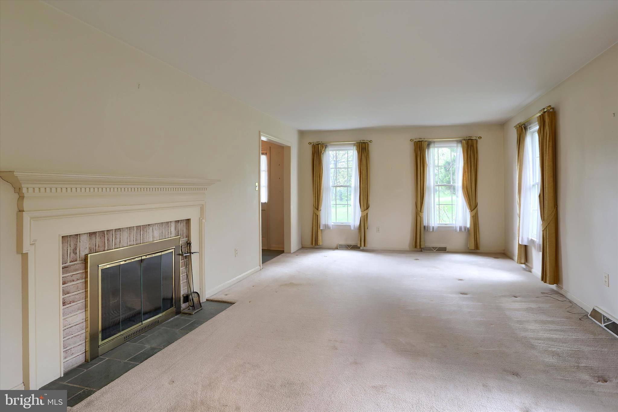 2919 Arcona Road Mechanicsburg, PA 17055 - Photo 6 of 49 an empty room with windows and a fireplace
