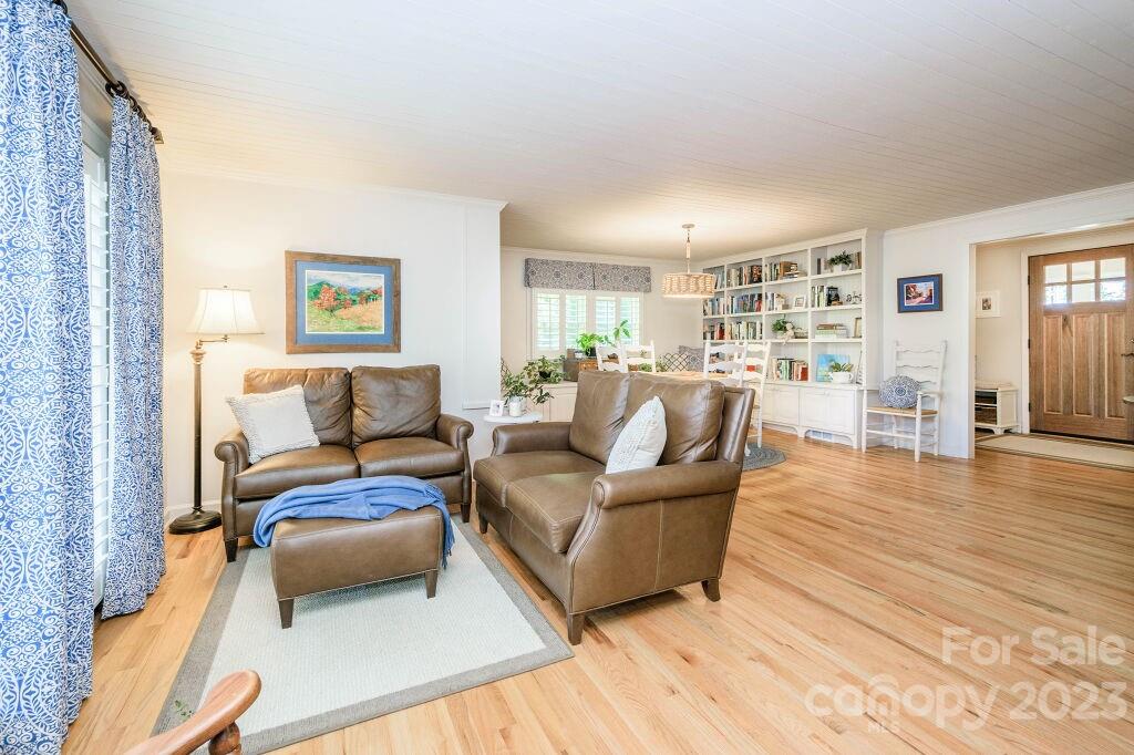 154 Rugby Drive Hendersonville, NC 28791 - Photo 11 of 48 a living room with furniture and a wooden floor