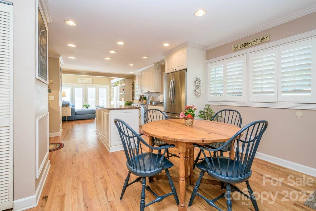 154 Rugby Drive Hendersonville, NC 28791 - Photo 12 of 48 a view of a dining room with furniture and wooden floor
