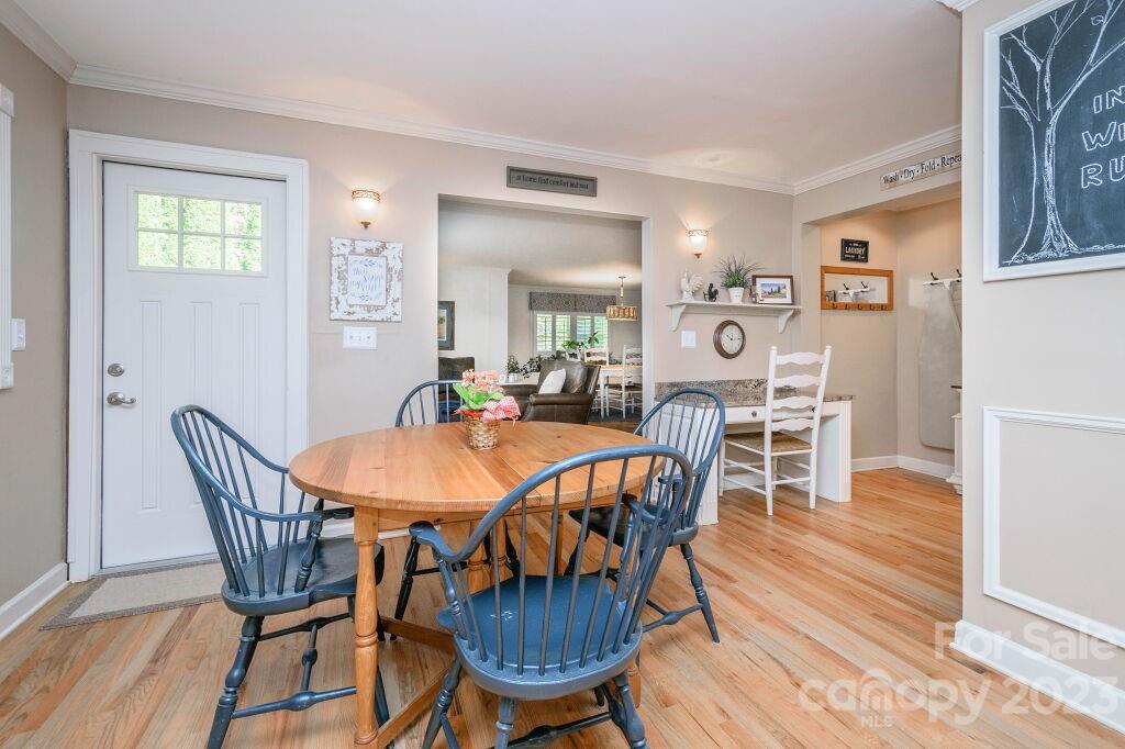 154 Rugby Drive Hendersonville, NC 28791 - Photo 13 of 48 a view of a dining room with furniture and wooden floor