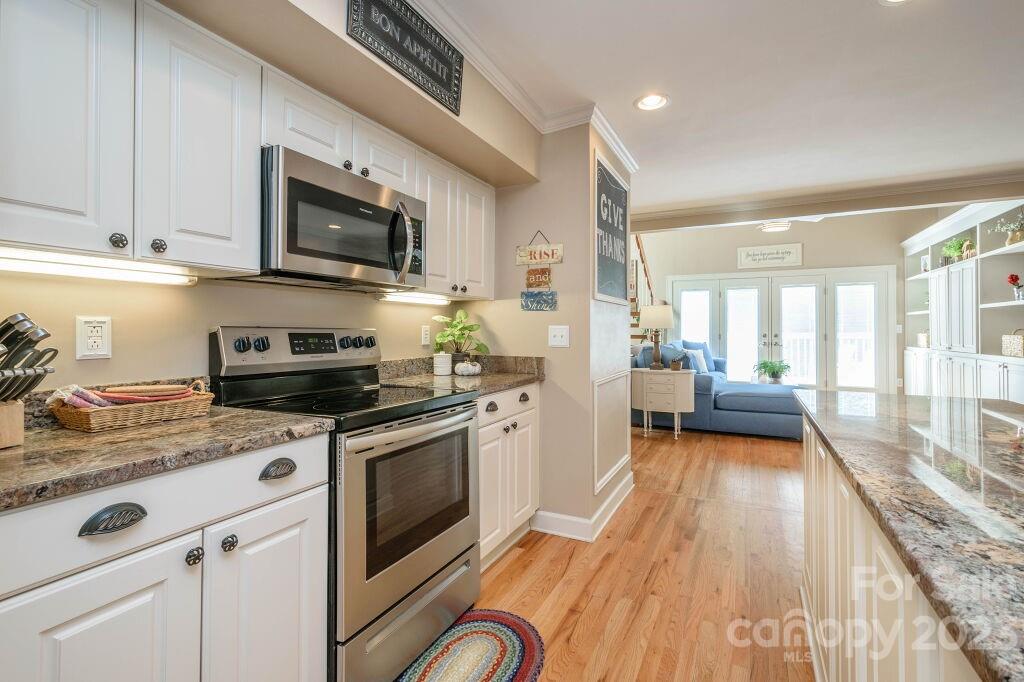 154 Rugby Drive Hendersonville, NC 28791 - Photo 15 of 48 a kitchen with stainless steel appliances a stove a sink and a microwave