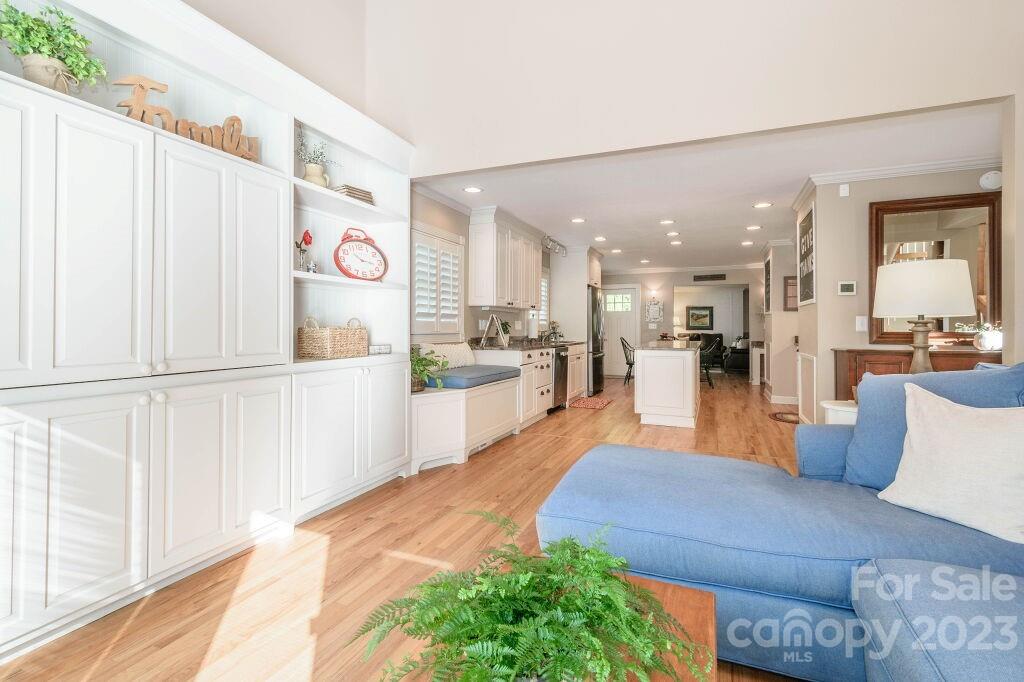 154 Rugby Drive Hendersonville, NC 28791 - Photo 23 of 48 a large white kitchen with stainless steel appliances kitchen island granite countertop a refrigerator and a view of living room
