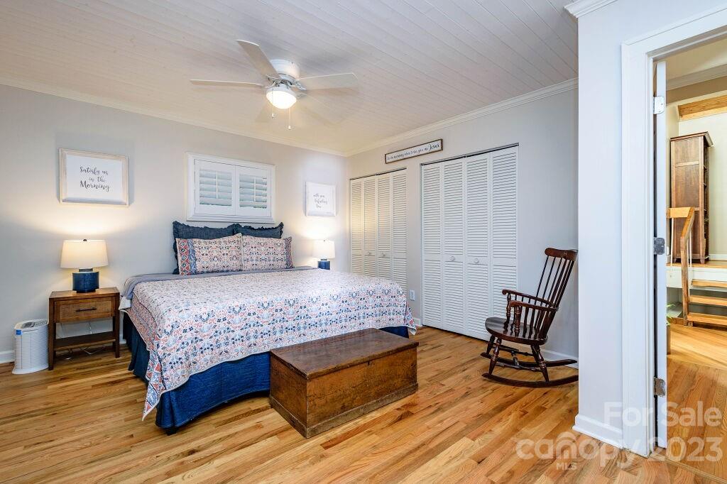 154 Rugby Drive Hendersonville, NC 28791 - Photo 27 of 48 a bedroom with a bed a chair and a window