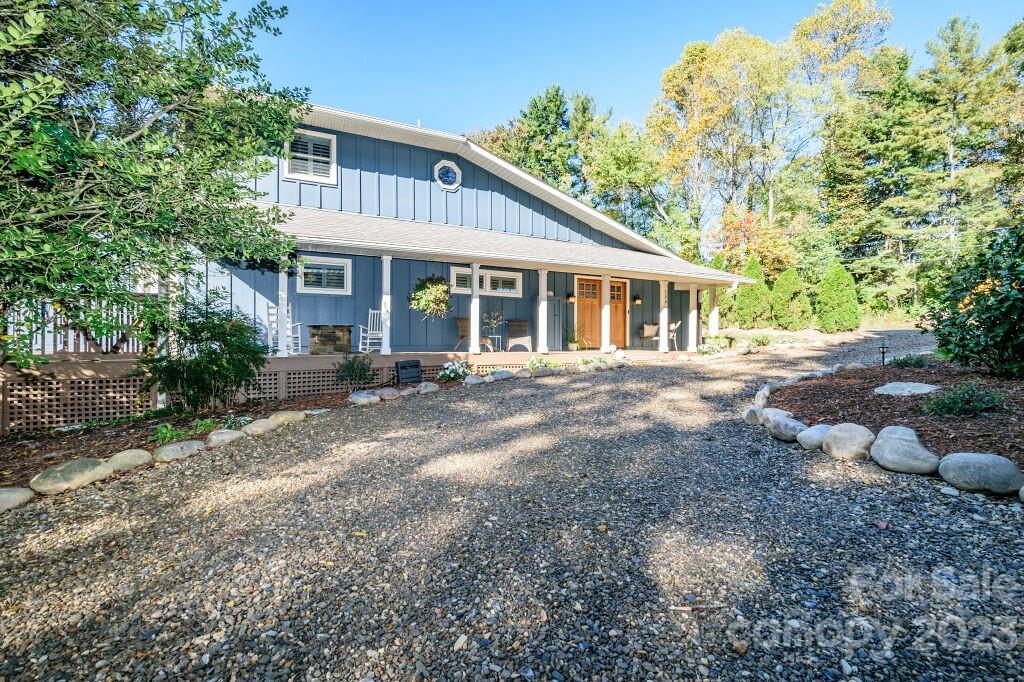 154 Rugby Drive Hendersonville, NC 28791 - Photo 3 of 48 a front view of a house with a garden