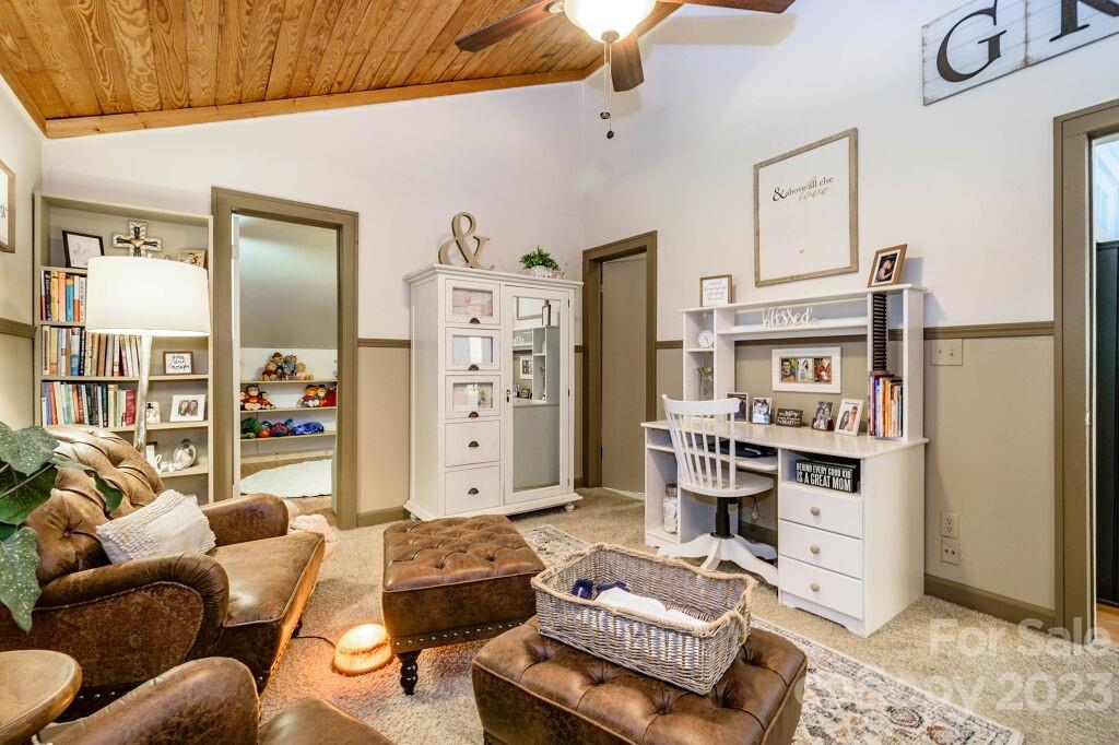 154 Rugby Drive Hendersonville, NC 28791 - Photo 33 of 48 a living room with furniture and a flat screen tv