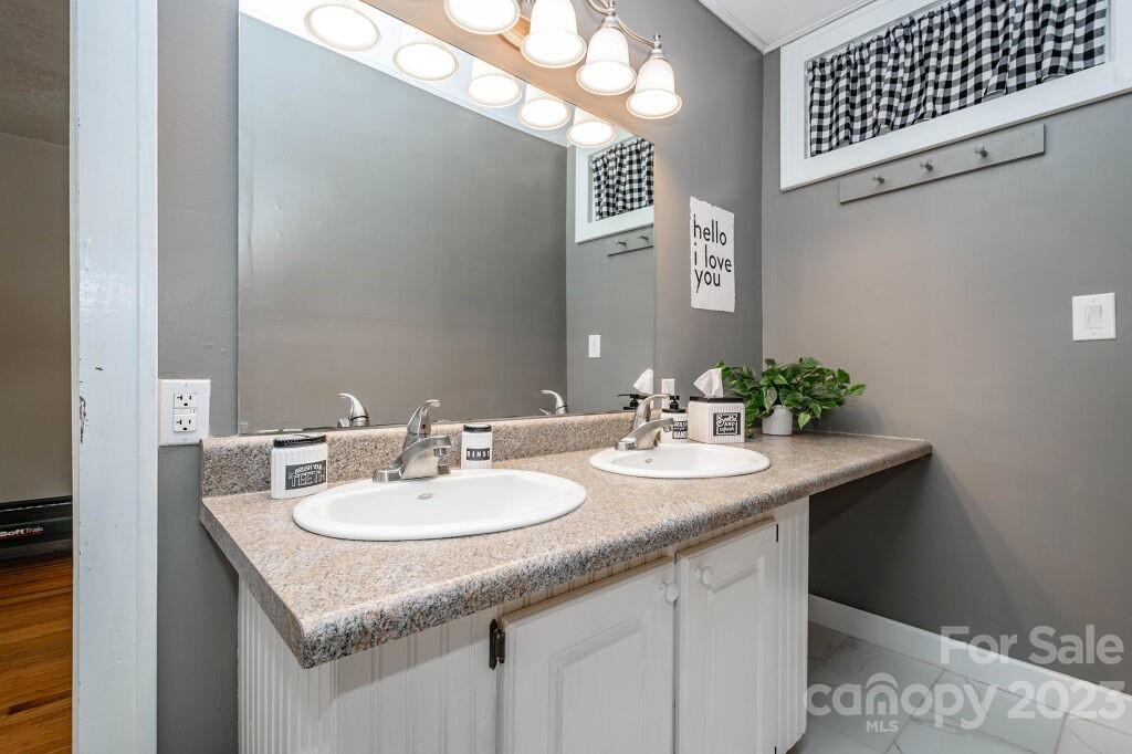 154 Rugby Drive Hendersonville, NC 28791 - Photo 35 of 48 a bathroom with a granite countertop sink and a mirror