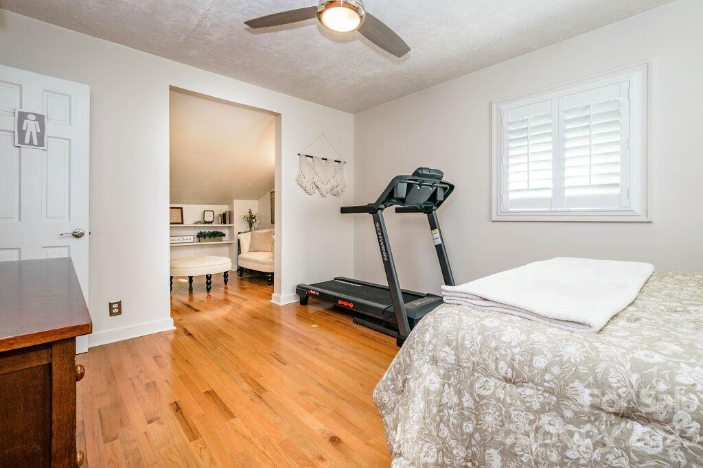 154 Rugby Drive Hendersonville, NC 28791 - Photo 38 of 48 a room with gym equipment and a wooden floor