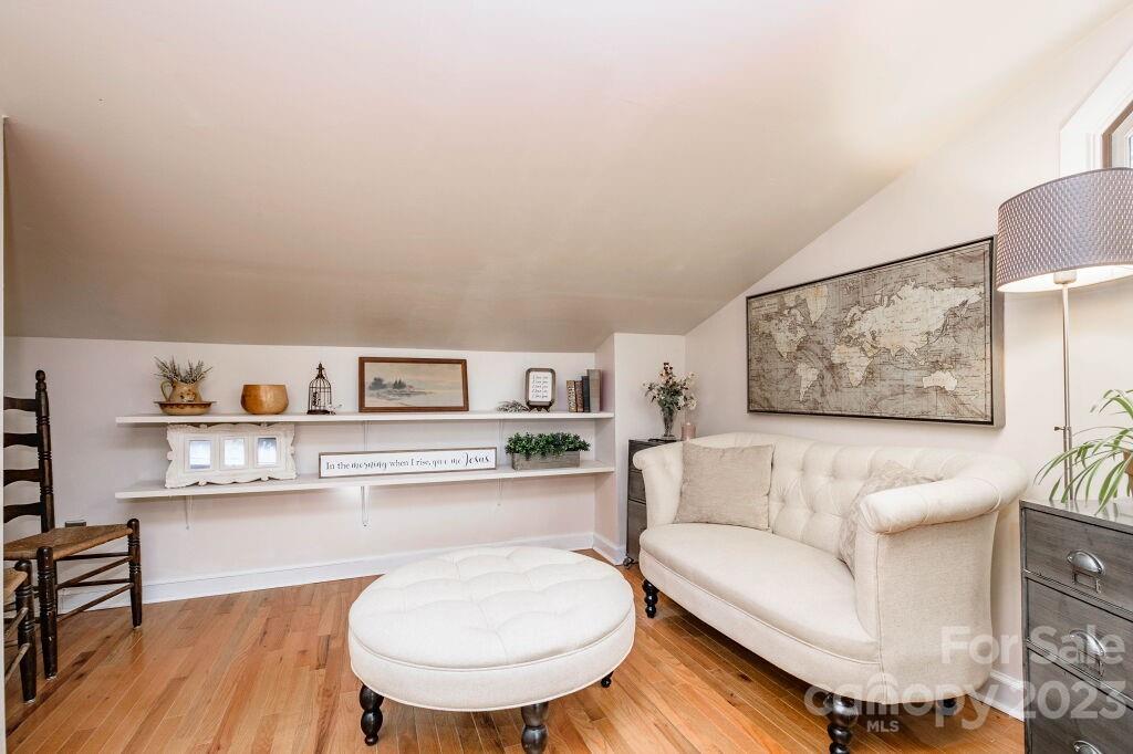154 Rugby Drive Hendersonville, NC 28791 - Photo 39 of 48 a living room with furniture and a wooden floor