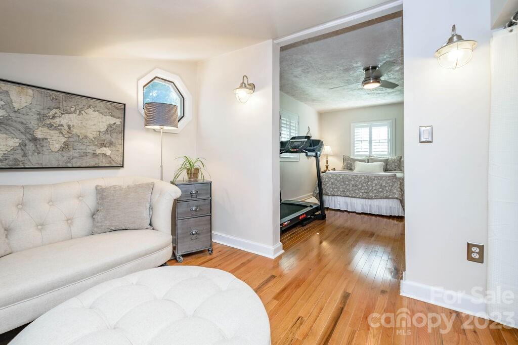 154 Rugby Drive Hendersonville, NC 28791 - Photo 40 of 48 a bedroom with furniture and a wooden floor