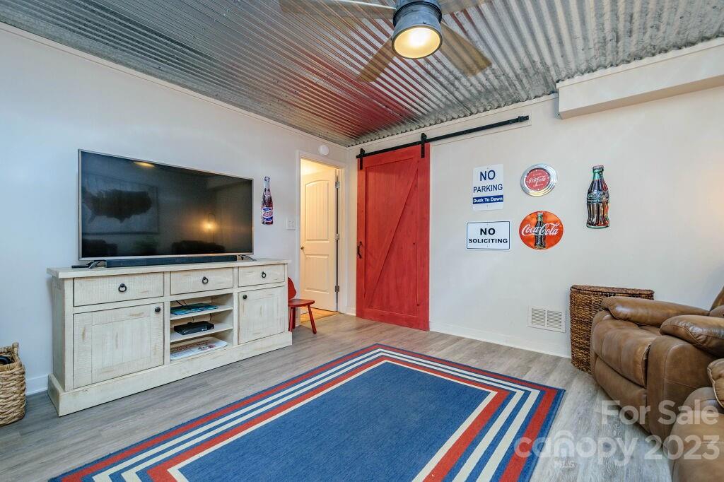 154 Rugby Drive Hendersonville, NC 28791 - Photo 42 of 48 a living room with furniture and a flat screen tv