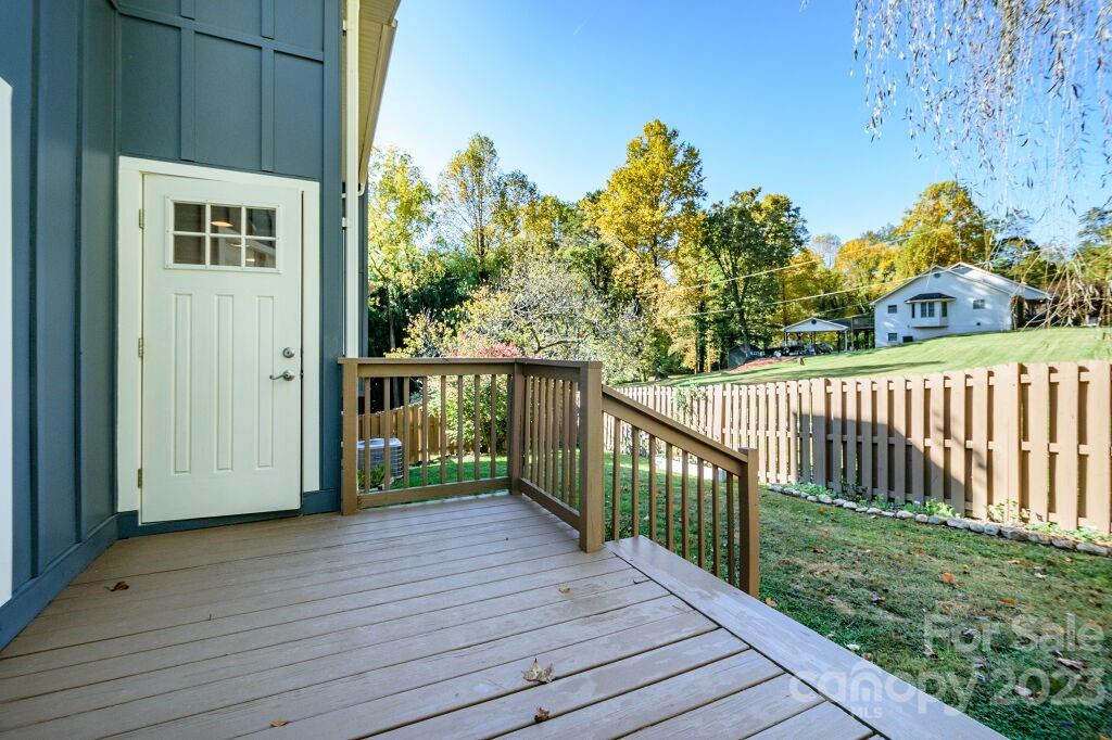 154 Rugby Drive Hendersonville, NC 28791 - Photo 43 of 48 a view of a porch with wooden floor and fence