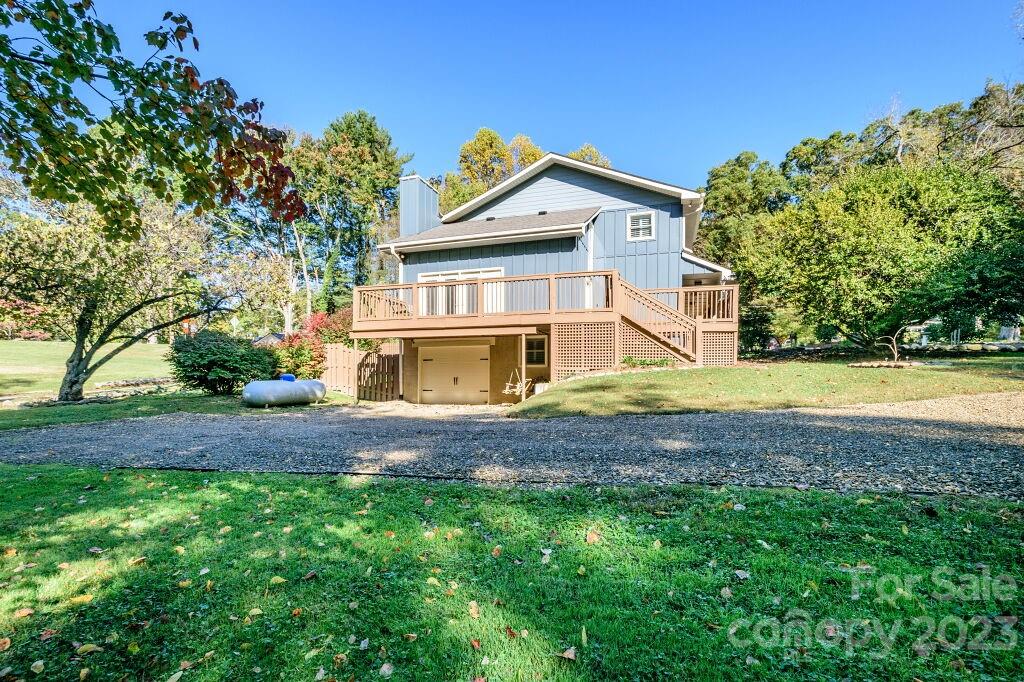 154 Rugby Drive Hendersonville, NC 28791 - Photo 46 of 48 a view of a house with a big yard and large trees