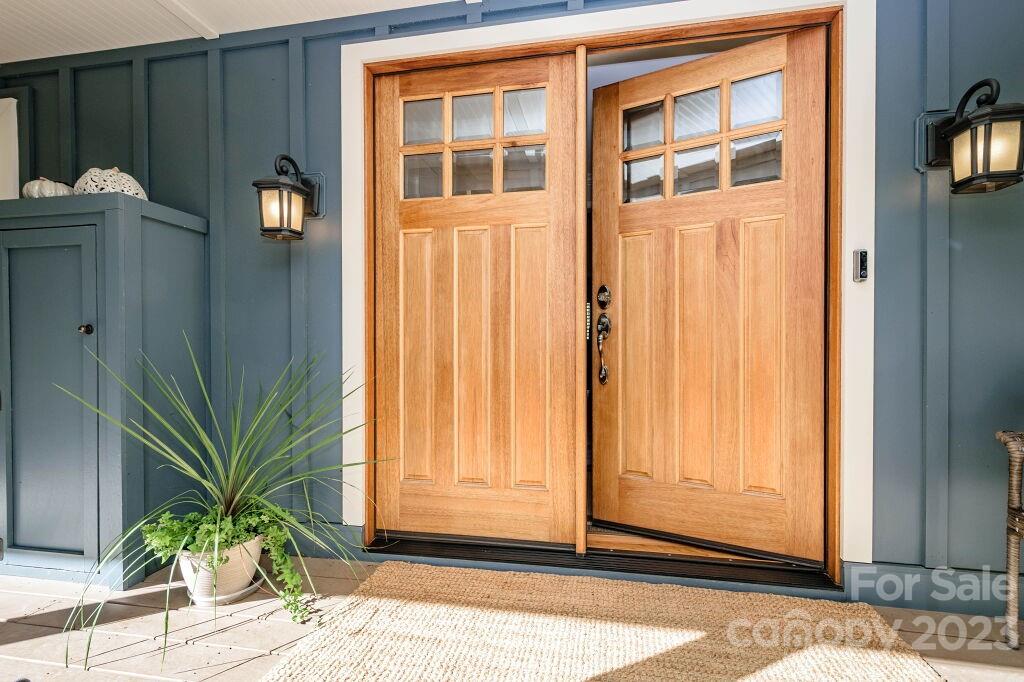 154 Rugby Drive Hendersonville, NC 28791 - Photo 5 of 48 a potted plant sitting in front of a door