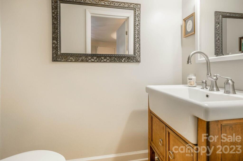 154 Rugby Drive Hendersonville, NC 28791 - Photo 7 of 48 a bathroom with a toilet sink and mirror