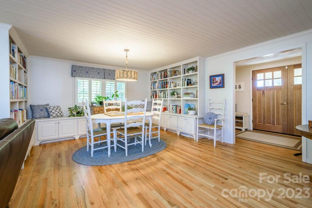 154 Rugby Drive Hendersonville, NC 28791 - Photo 10 of 48 a dining room with furniture and wooden floor