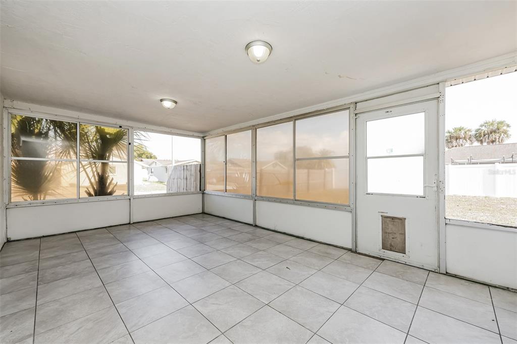 9436 Legend Lane Port Richey, FL 34668 - Photo 11 of 21 a view of an empty room with a window