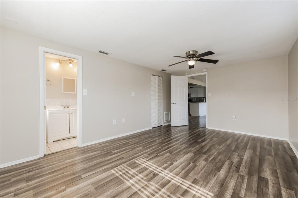 9436 Legend Lane Port Richey, FL 34668 - Photo 12 of 21 a view of an empty room with wooden floor and a window