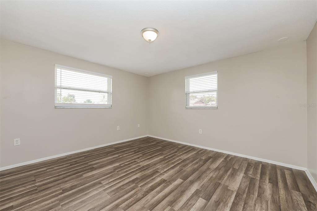 9436 Legend Lane Port Richey, FL 34668 - Photo 14 of 21 wooden floor in an empty room with a window