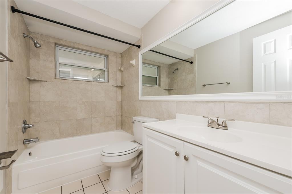 9436 Legend Lane Port Richey, FL 34668 - Photo 18 of 21 a bathroom with a sink a toilet and shower