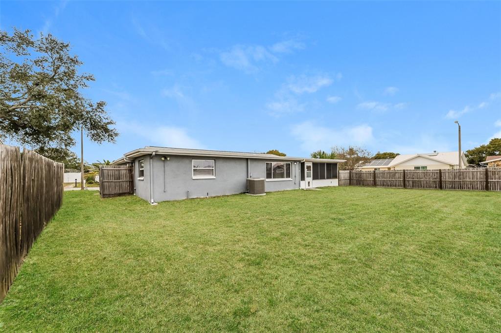 9436 Legend Lane Port Richey, FL 34668 - Photo 19 of 21 a view of a house with a back yard