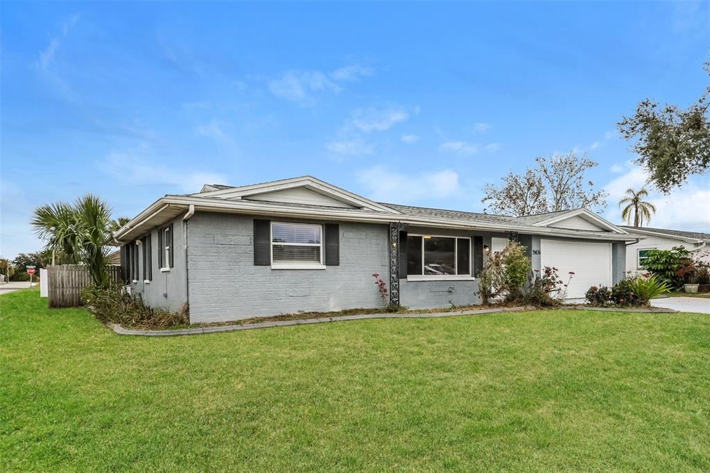 9436 Legend Lane Port Richey, FL 34668 - Photo 2 of 21 a front view of house with yard and trees