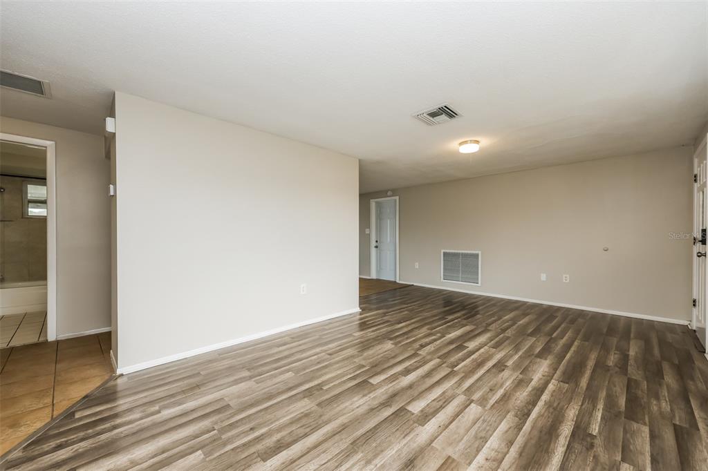 9436 Legend Lane Port Richey, FL 34668 - Photo 3 of 21 a view of an empty room and wooden floor