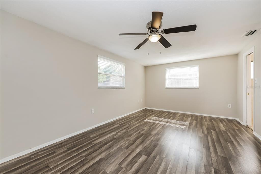 9436 Legend Lane Port Richey, FL 34668 - Photo 5 of 21 a view of a room with wooden floor and windows