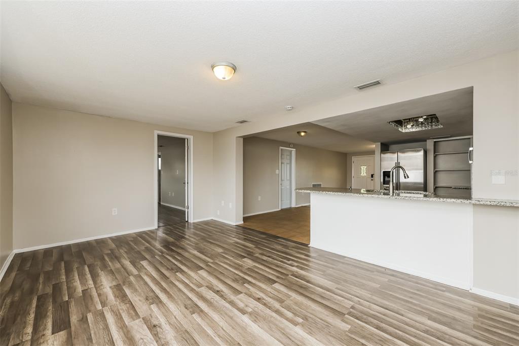 9436 Legend Lane Port Richey, FL 34668 - Photo 6 of 21 a view of a room with wooden floor and a window