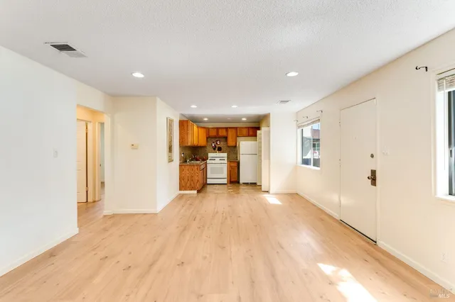 a view of a big room with wooden floor and a bathroom