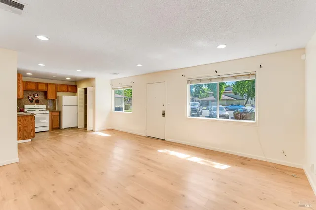 an empty room with windows and entrance