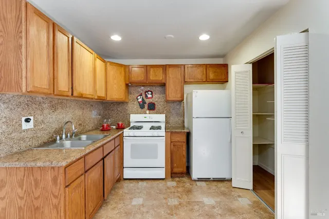 a kitchen with refrigerator and cabinets