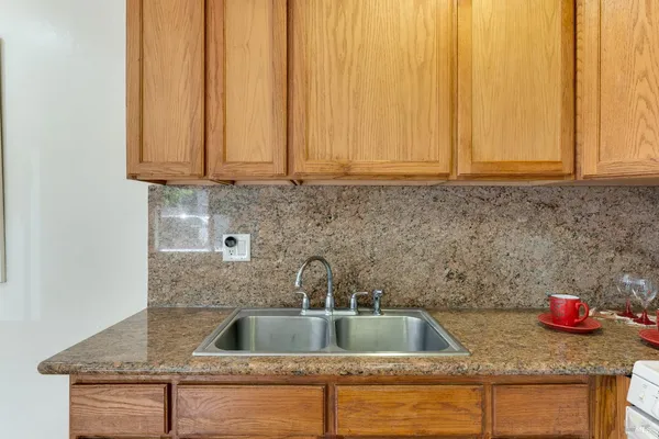 a kitchen sink with granite countertop a sink
