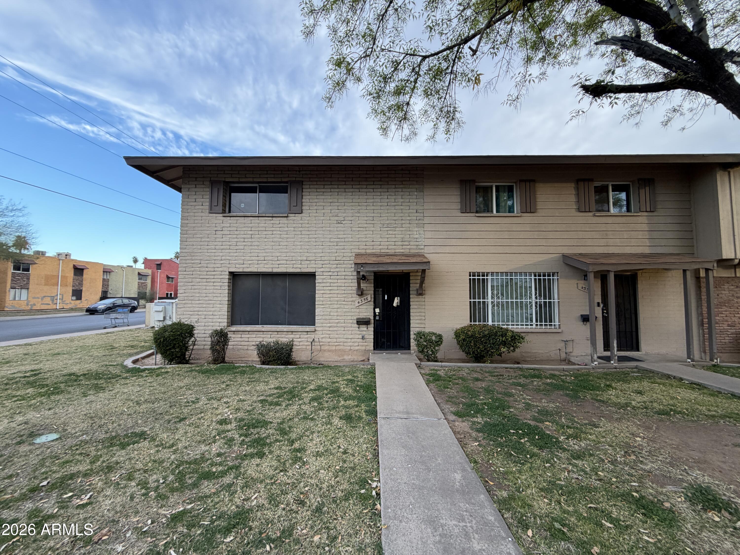 a front view of a house with garden