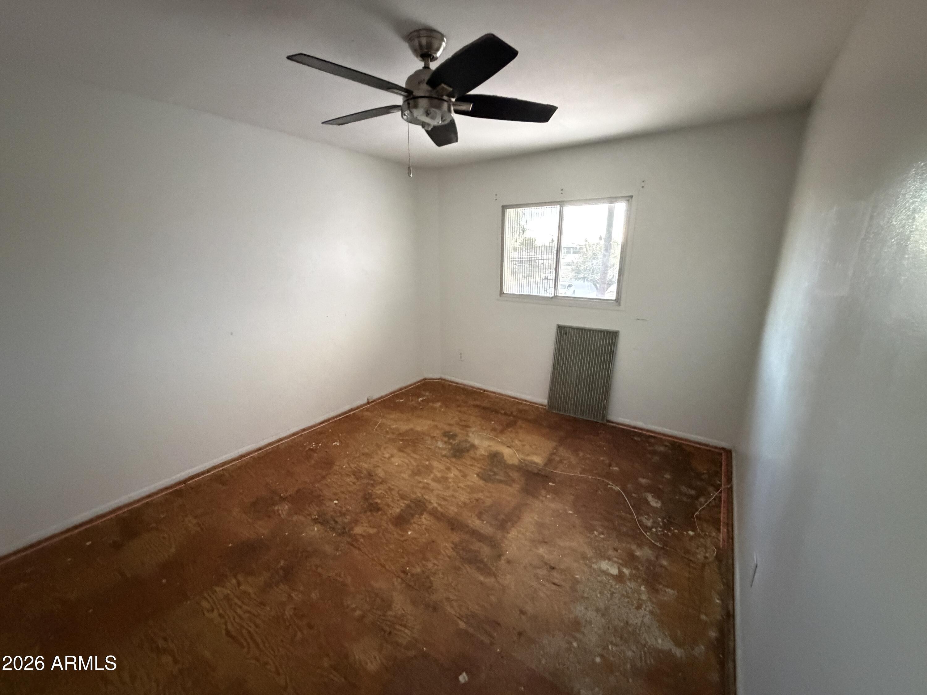 4356 West Ocotillo Road Glendale, AZ 85301 - Photo 11 of 16 an empty room with a window and a ceiling fan