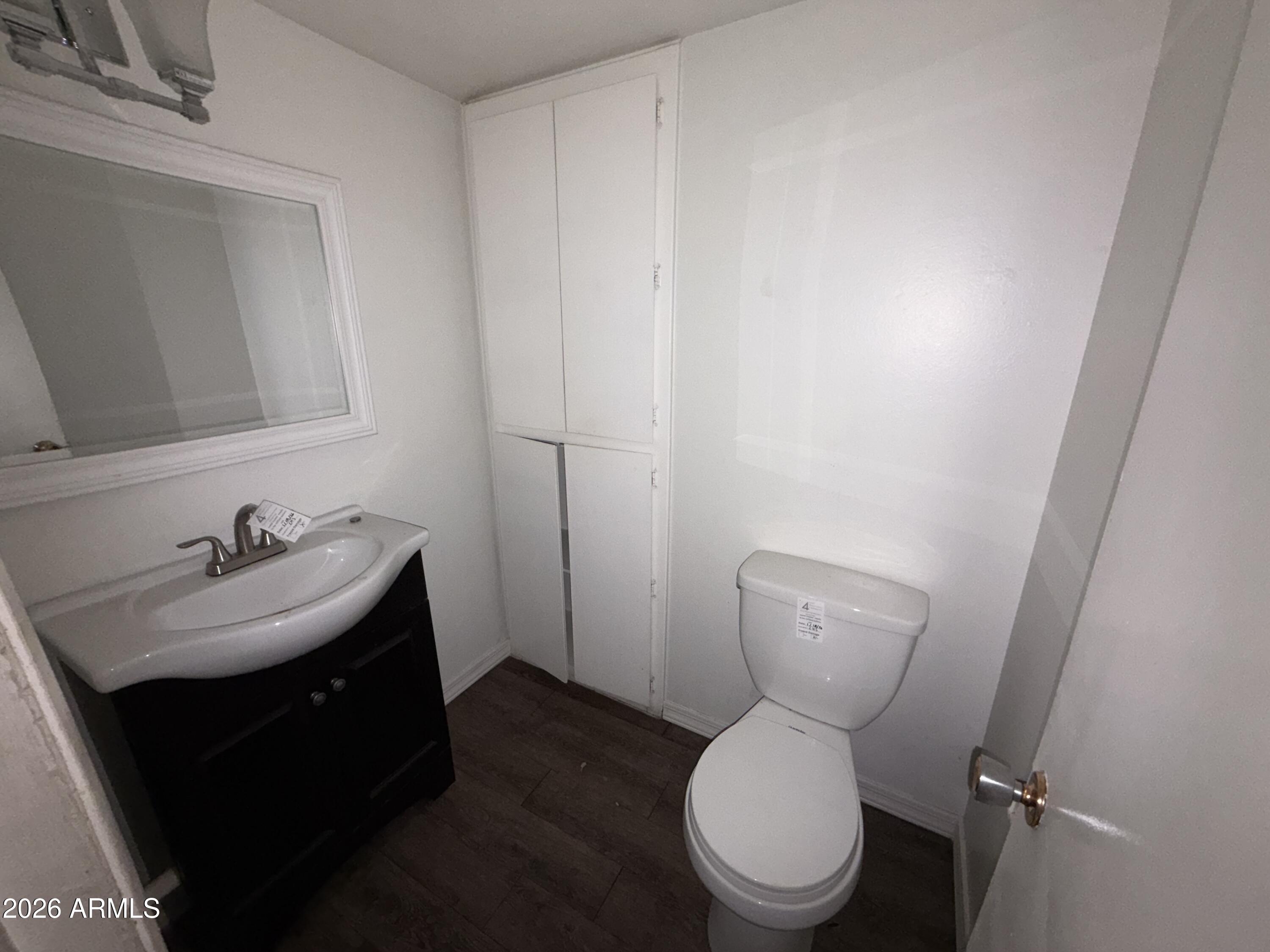 4356 West Ocotillo Road Glendale, AZ 85301 - Photo 16 of 16 a bathroom with a toilet sink and mirror