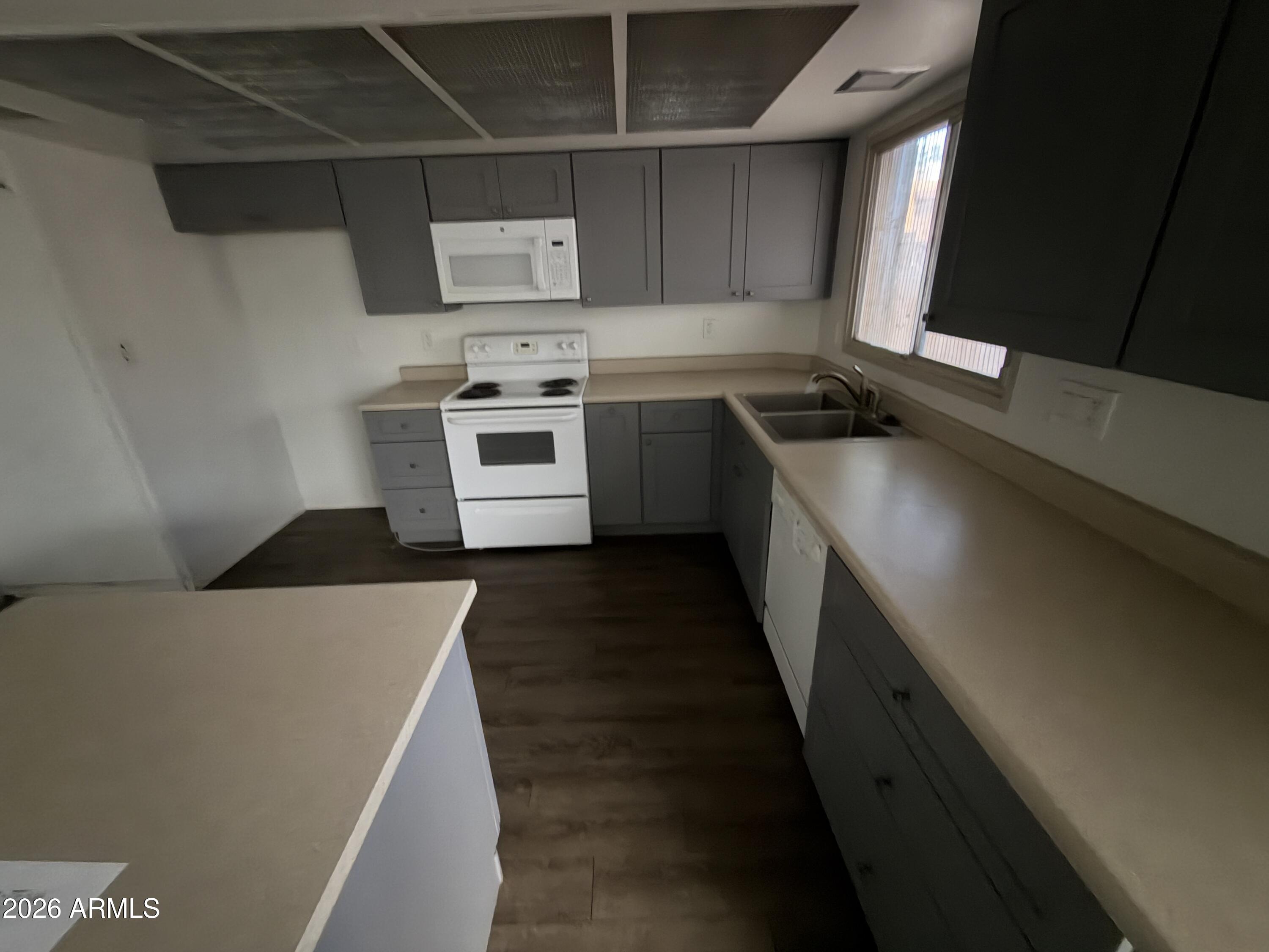 4356 West Ocotillo Road Glendale, AZ 85301 - Photo 5 of 16 a kitchen with stainless steel appliances a stove a sink and a refrigerator