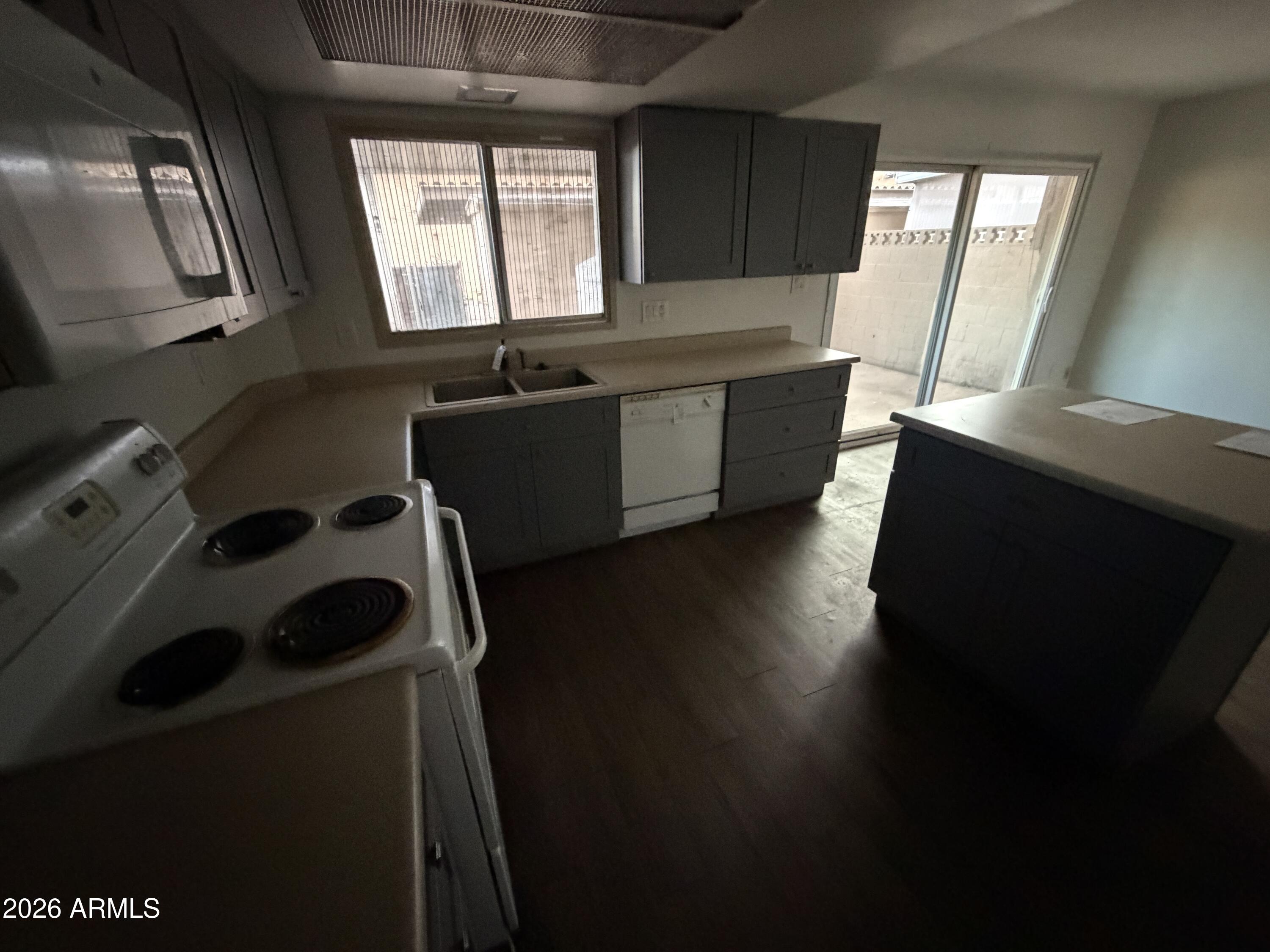 4356 West Ocotillo Road Glendale, AZ 85301 - Photo 6 of 16 a kitchen with a window a sink and a stove