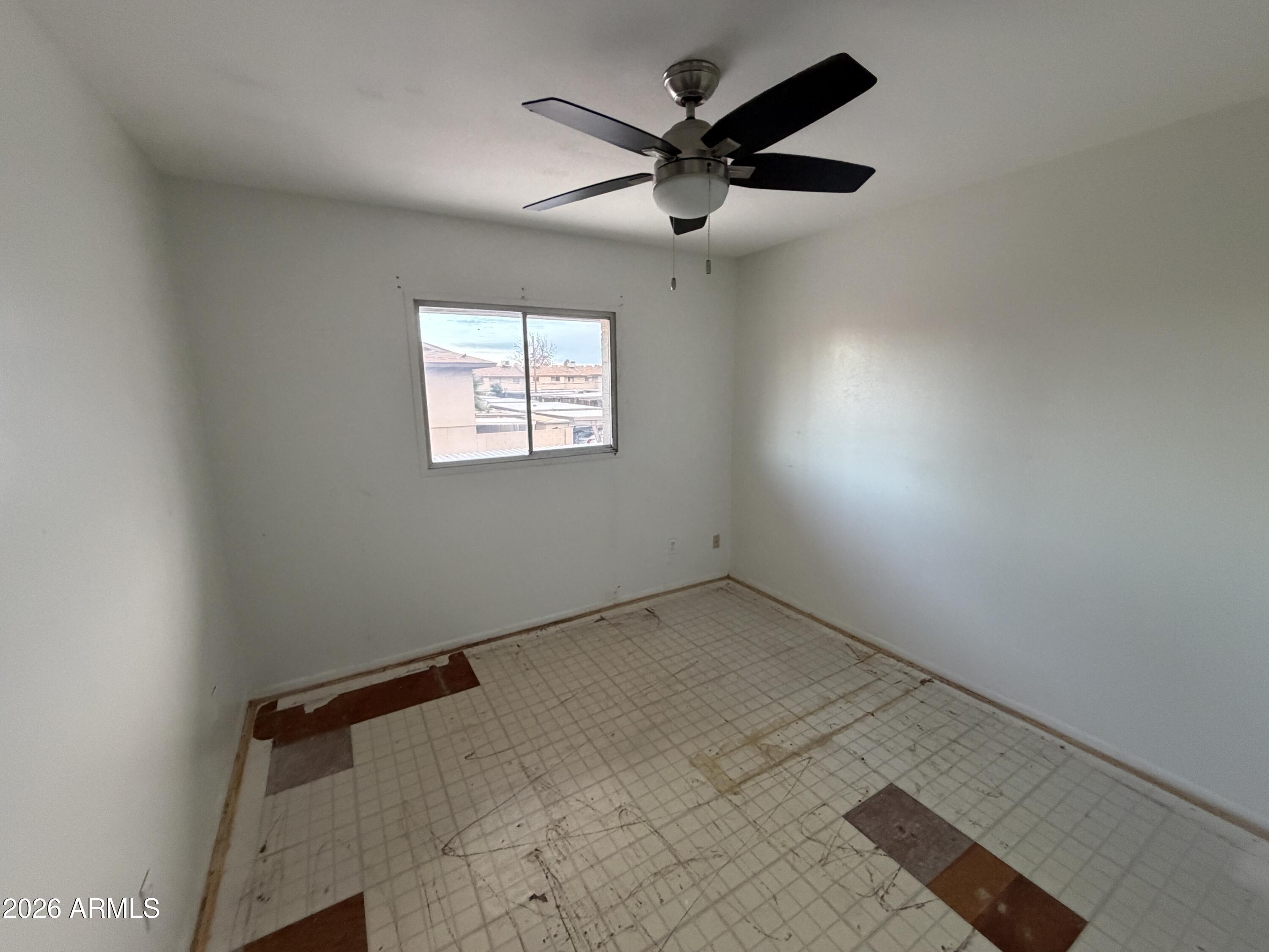 4356 West Ocotillo Road Glendale, AZ 85301 - Photo 9 of 16 an empty room with a window and a fan